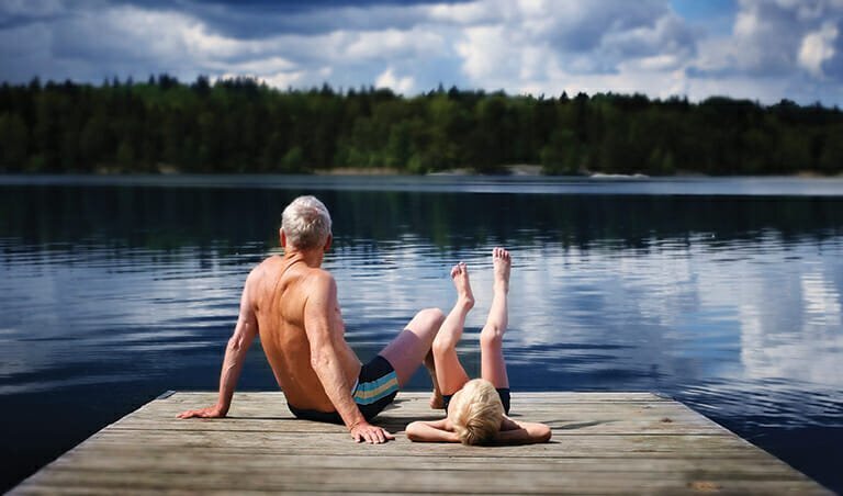 Grandfather and Grandson sitting on a footbridge | Tennessee Gated Communities